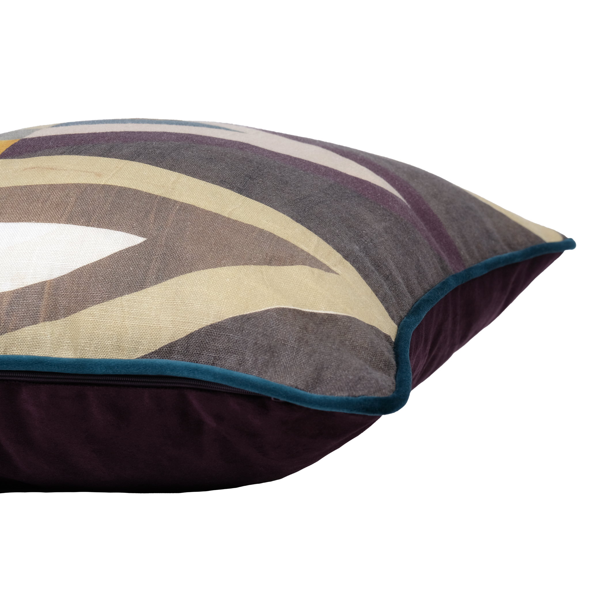 A close-up of a decorative throw pillow featuring an abstract geometric pattern in taupe, beige, and purple with a dark teal piped edge and a deep aubergine velvet reverse side.