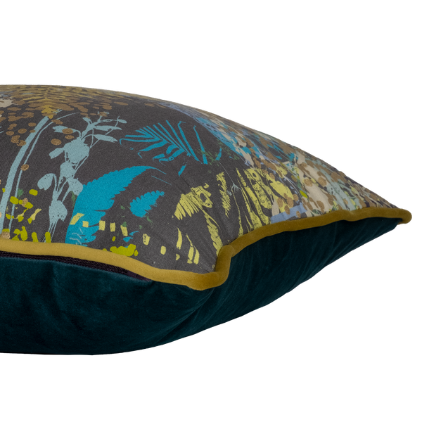 Side shot of a decorative cushion with botanical silhouettes in multiple colours on a grey background