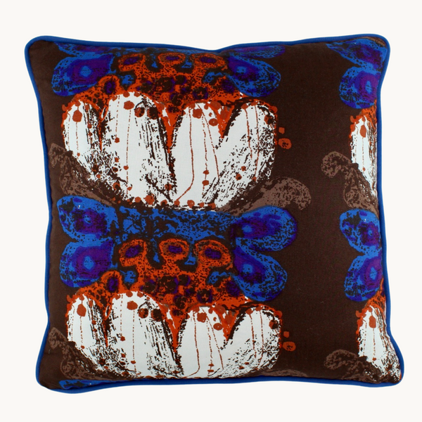 Photo of a cushion made from a 1970 vintage fabric reminiscent of german pottery.