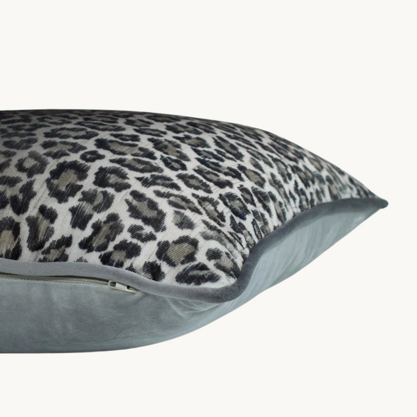 Side shot of a cushion made from a leopard print velvet in cool silver tones