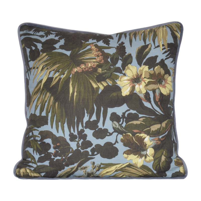Floral and leaf patterned cushion on a light blue background