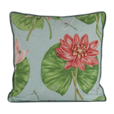 Decorative cushion with pink lotus flowers and green leaves on a light blue background
