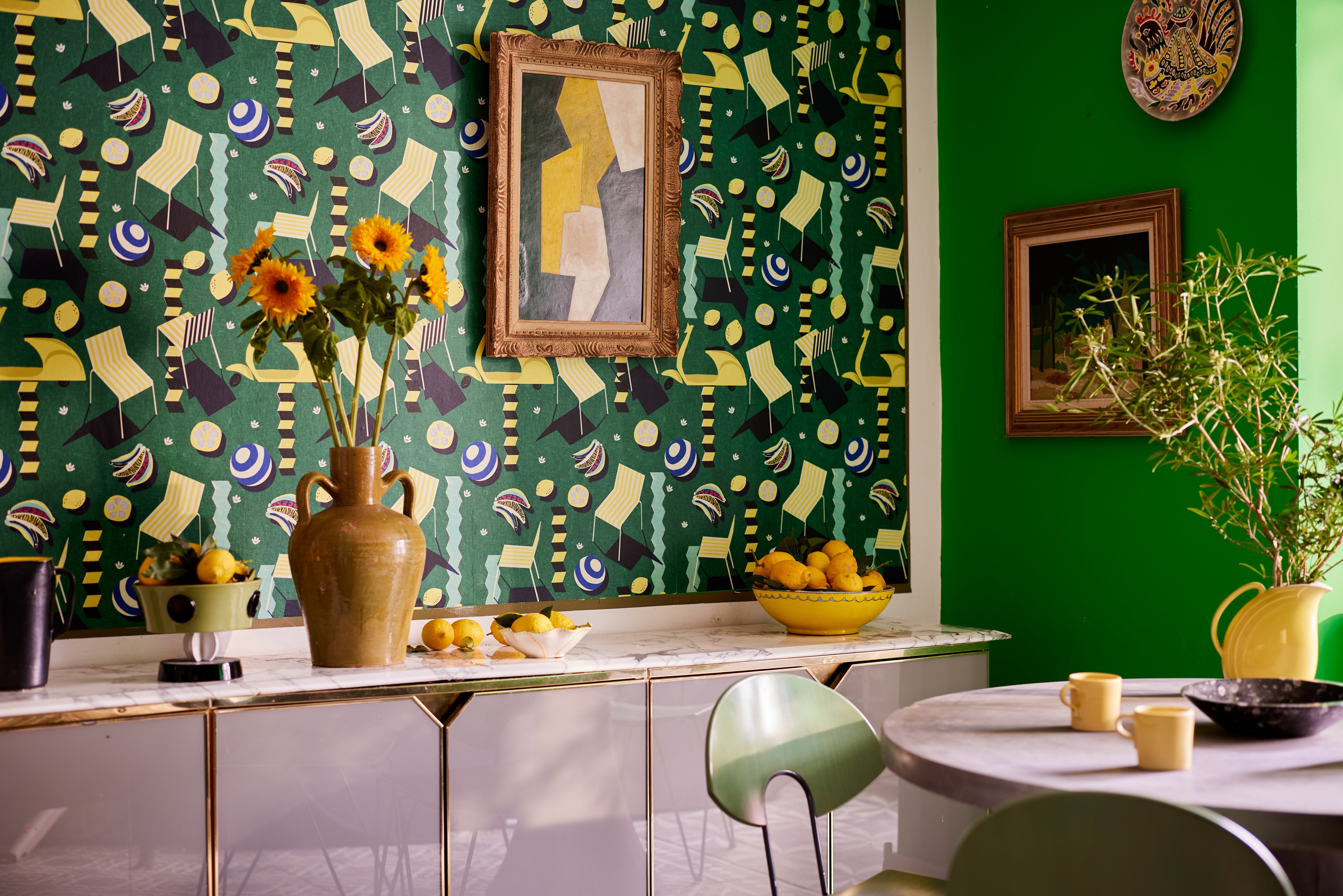 Kitchen with MOTO BELLO Green wallpaper, complemented by vibrant decor,  lush greenery decorative sunflowers and lemons in a bowl