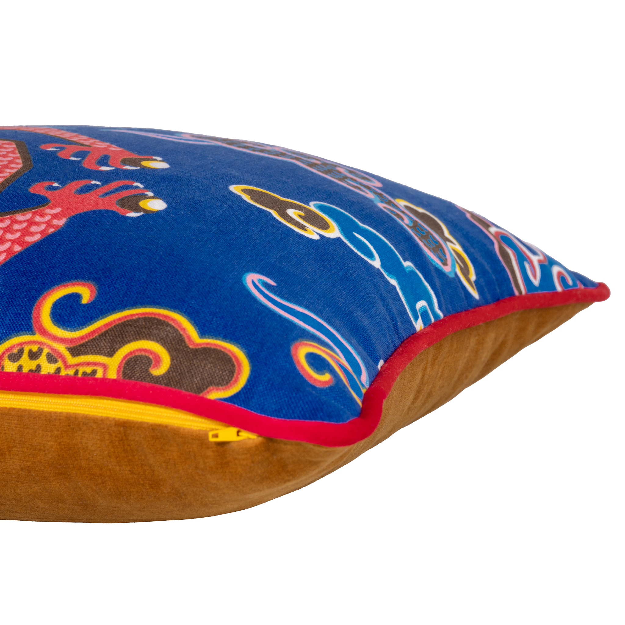 Side shot of a decorative pillow with a red dragon design on a blue background