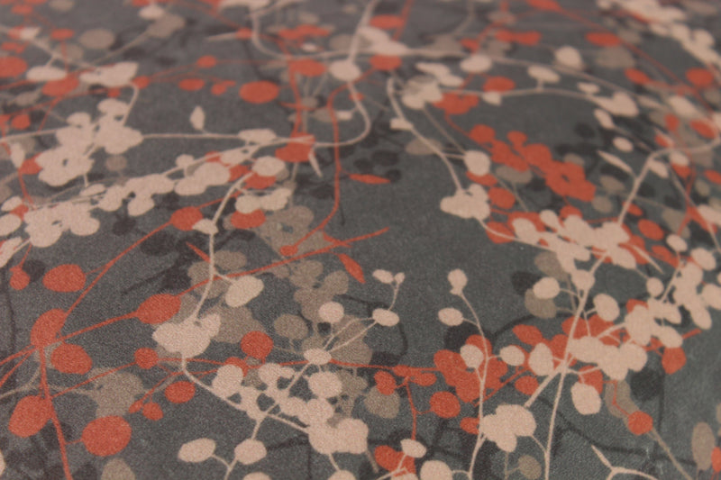 Close up of velvet with delicate leafy vines in mole and clay colours.