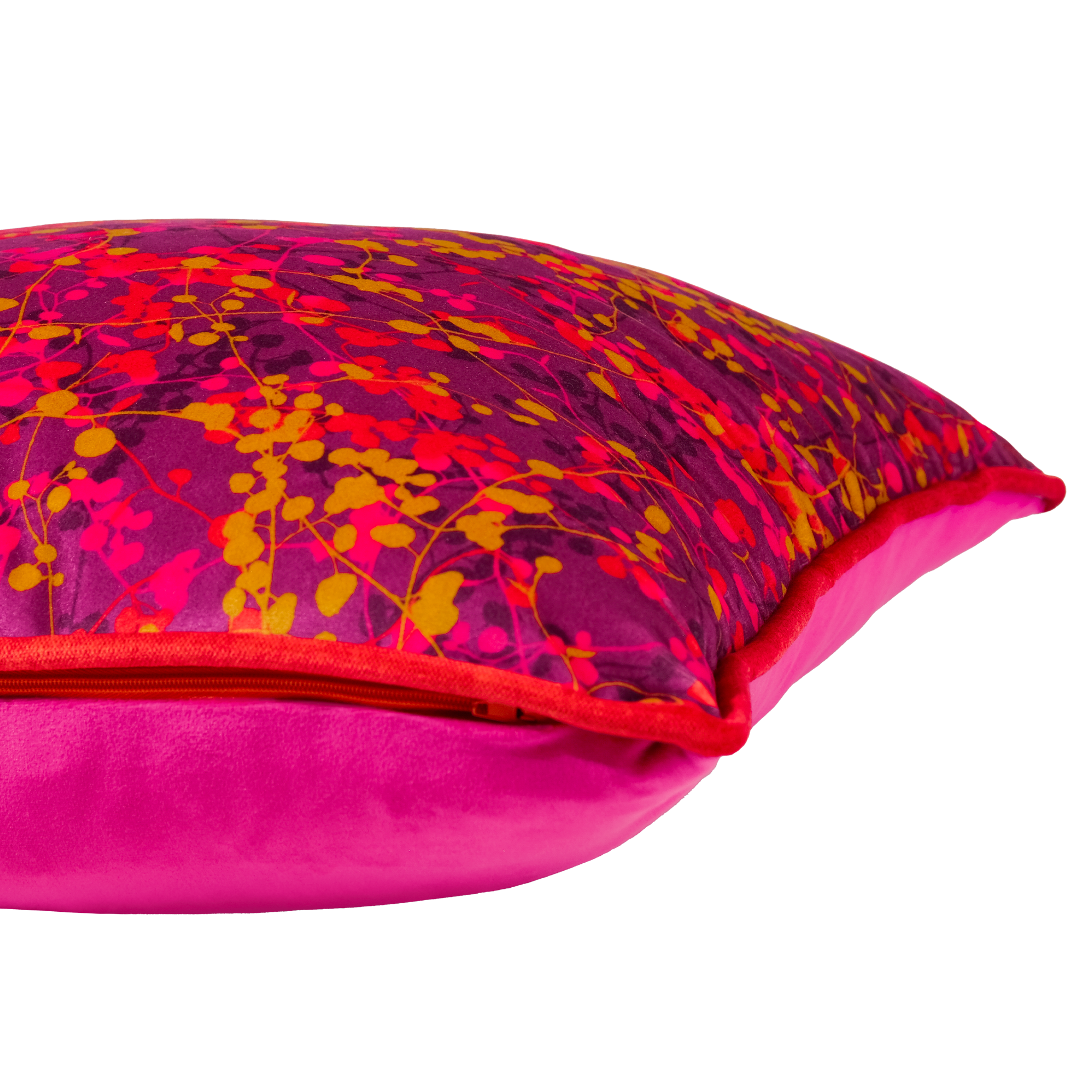Velvet cushion with a bright leafy pattern in pink and orange