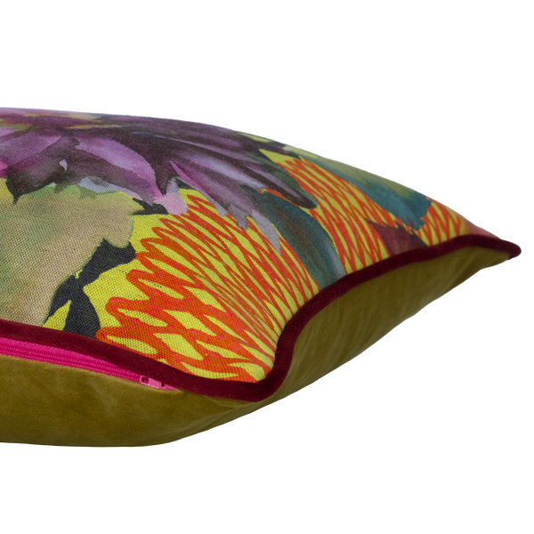 Side shot of a printed linen cushion in bright colours with  a floral and geometric design