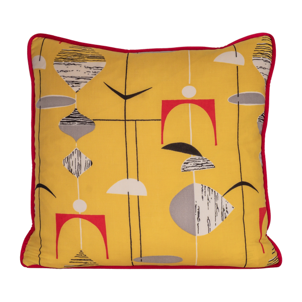 Colourful cushion made from a vintage fabric with geometric shapes on a bright yellow base.