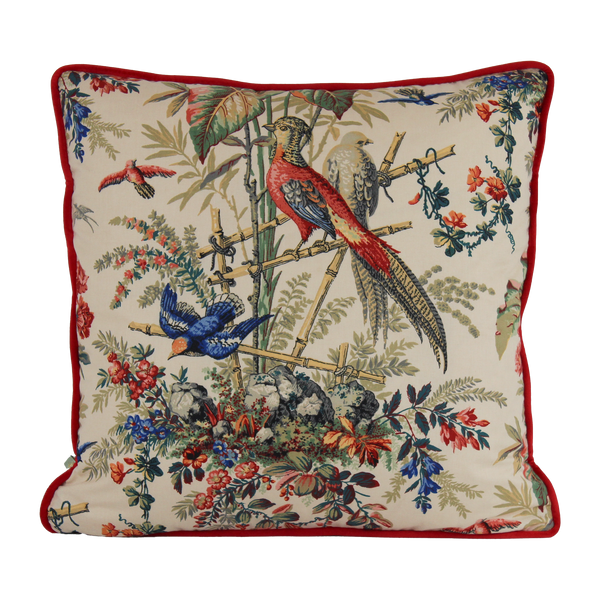 Decorative pillow with bird and floral pattern on a white background