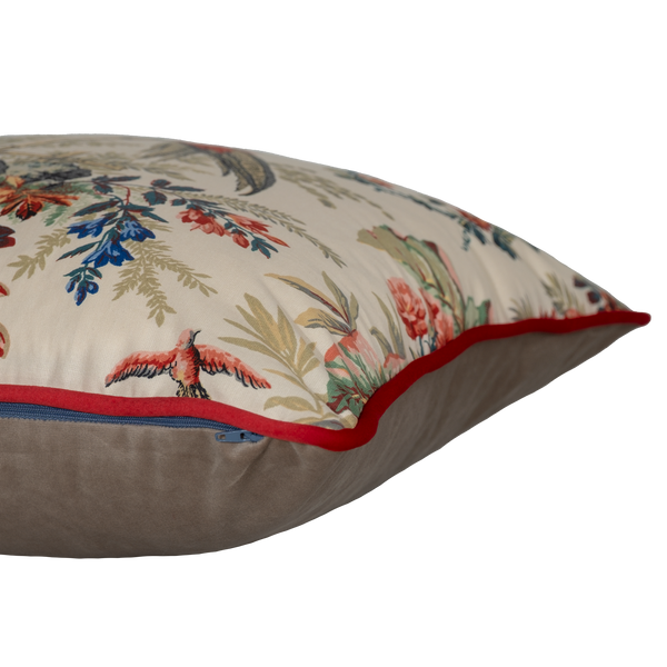 Decorative pillow with floral and bird pattern on a beige background