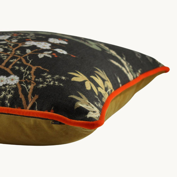 photo of a cushion made from a vintage linen with bamboo and cherry blossoms in a classic 1970s colourway or chocolate brown and bright orange.