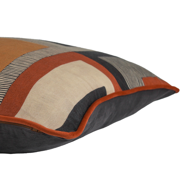 Side shot of a geometric linen cushion in black, rust, and tan linen