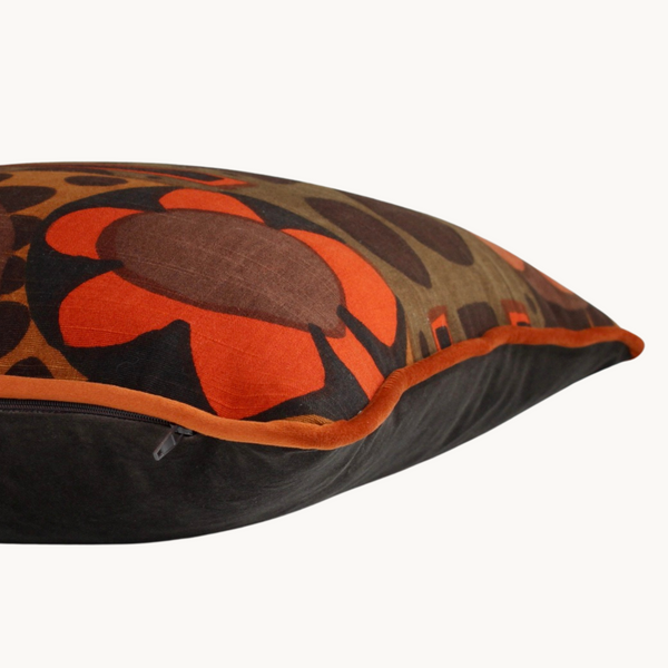 Side shot of a cushion made from vintage fabric from the 1970s - a large scale design in a classic 70s palette of orange and brown