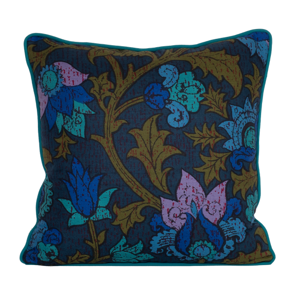 Photo of a cushion made from a 1970s printed damask in bright blue and purple