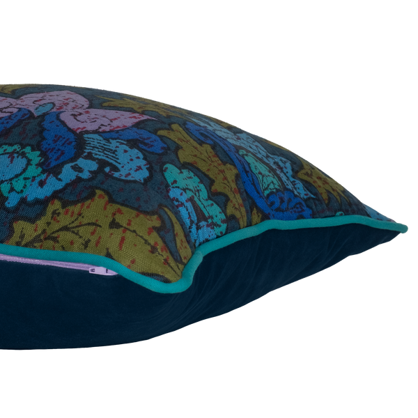 Side shot of a cushion made from a 1970s printed damask in bright blue and purple