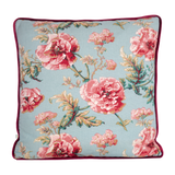 Floral patterned cushion with pink flowers on a light blue background