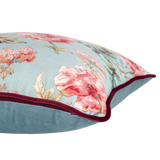 Floral-patterned pillow with pink flowers on a light blue background
