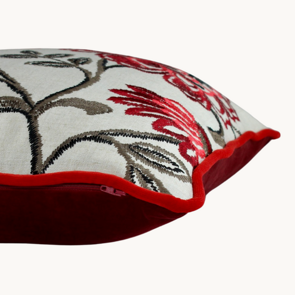 Side shot of a floral cushion with red embroidered flowers