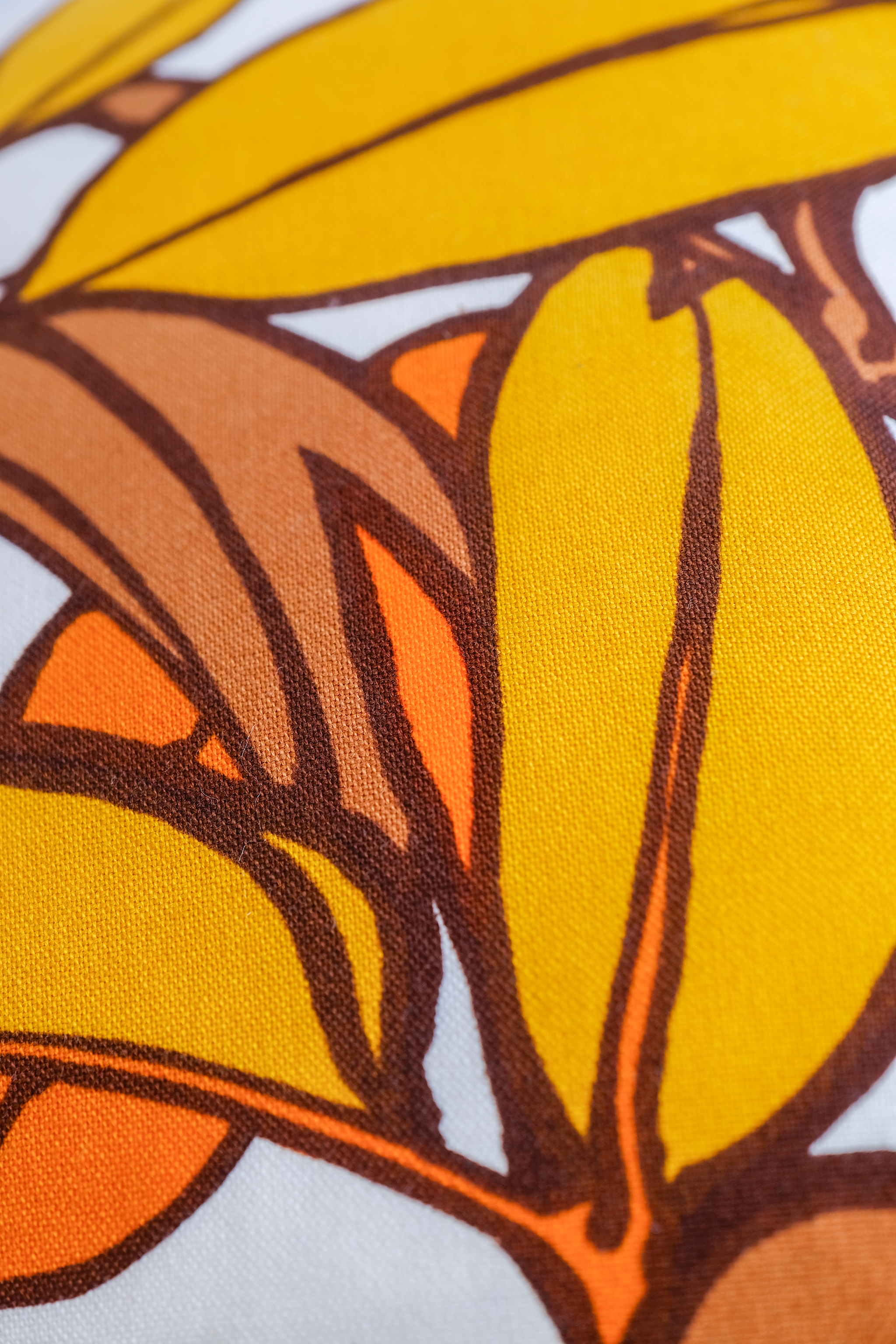 Close-up of a fabric with orange and yellow leaf pattern
