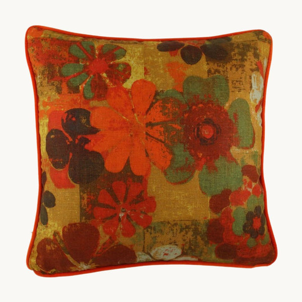 photo of a cushion made from a vintage linen  with a distinct 1970s feel - bright orange, green, chocolate and gold stylised flowers.