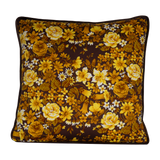 Photo of a 1970s inspired medium scale floral in bright yellow and ochre with a chocolate brown background
