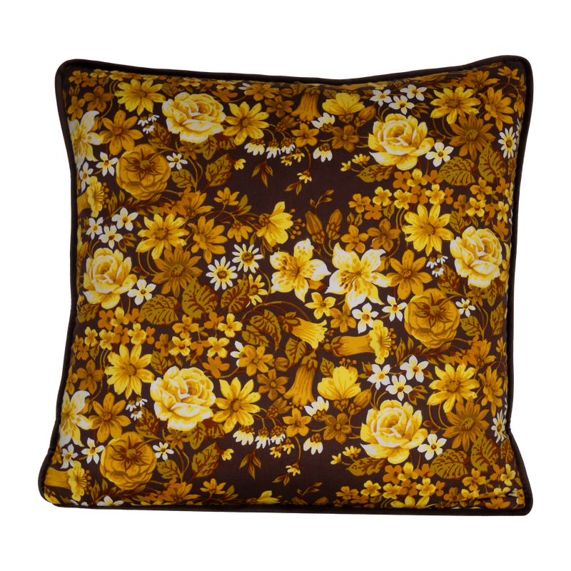 Photo of a 1970s inspired medium scale floral in bright yellow and ochre with a chocolate brown background