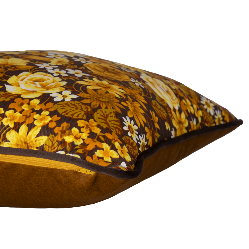 Side view of a 1970s inspired medium scale floral in bright yellow and ochre with a chocolate brown background