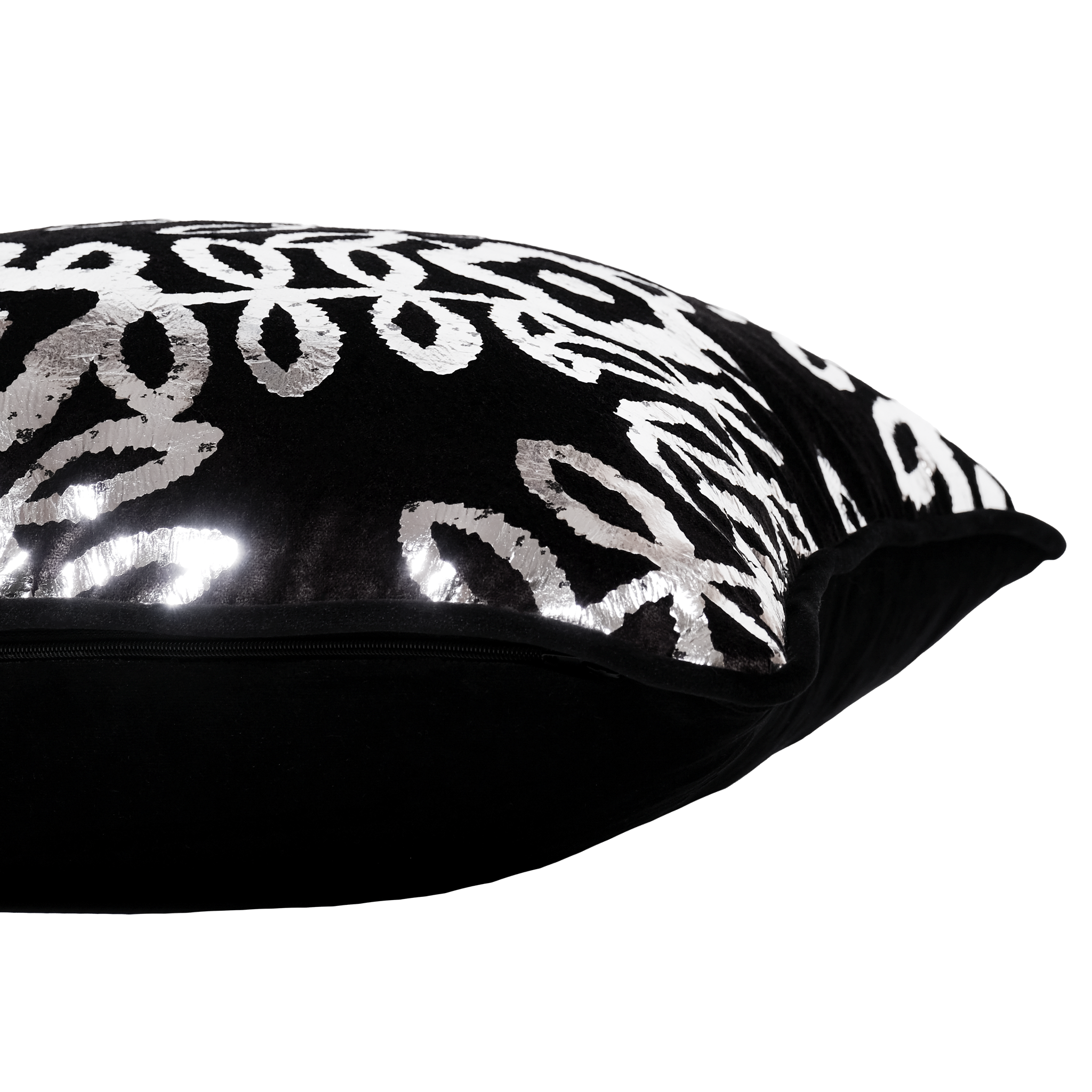 Side shot of a cushion in black velvet with a shiny metallic silver foil floral pattern