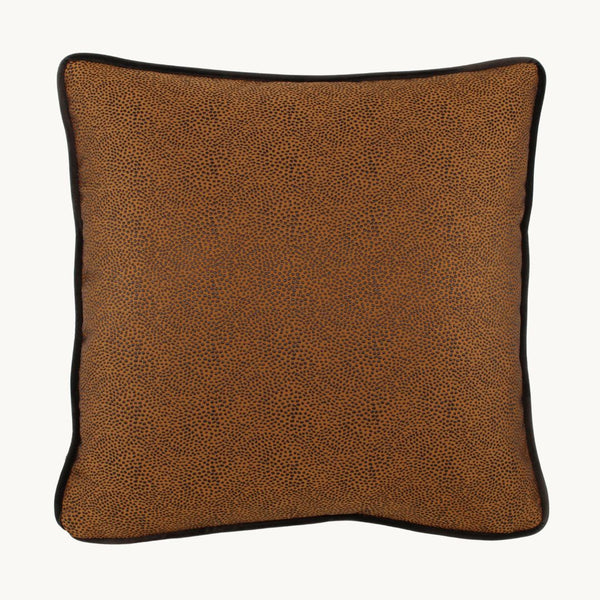 Photo of a rich earthy tobacco coloured cushion with a diffuse textured spot