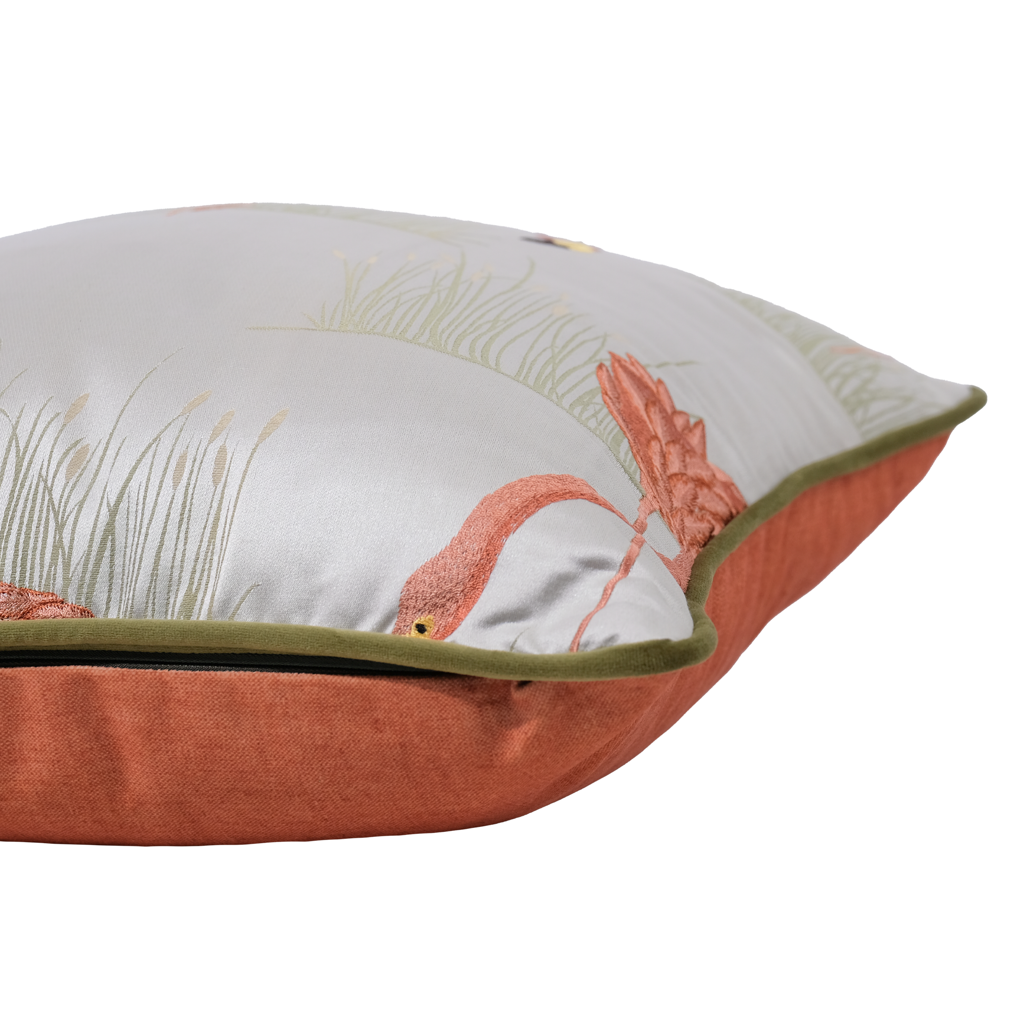 A square decorative throw pillow with a light gray top panel featuring a pink flamingo and green reeds, finished with a rust-orange velvet-like bottom border and olive green piping.