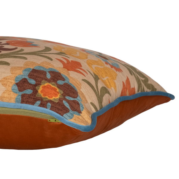 Side shot of a decorative cushion with a spanish inspired damask in autumn colours
