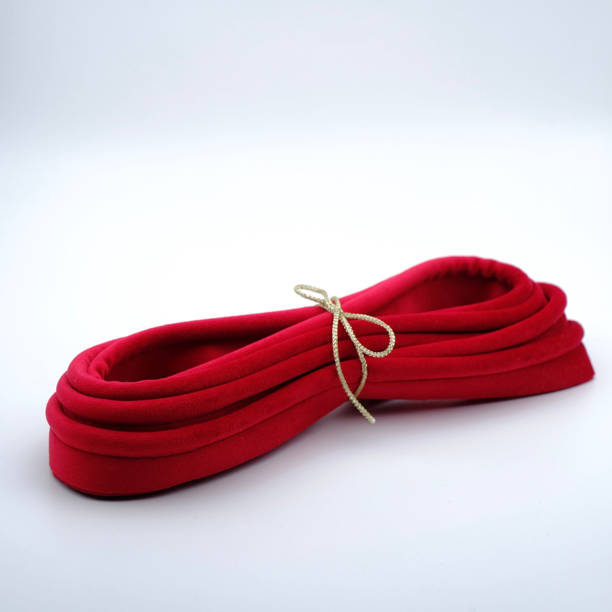 Photo of a bundle of scarlet coloured piping.