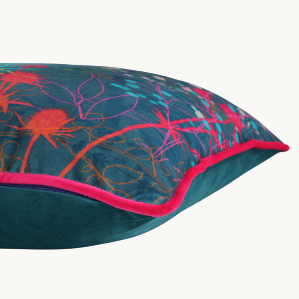Side shot of a vibrant coloured velvet botanical cushion