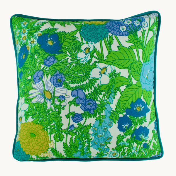 Photo of a very bright floral cushion in lime green with periwinkle blue and violet flower