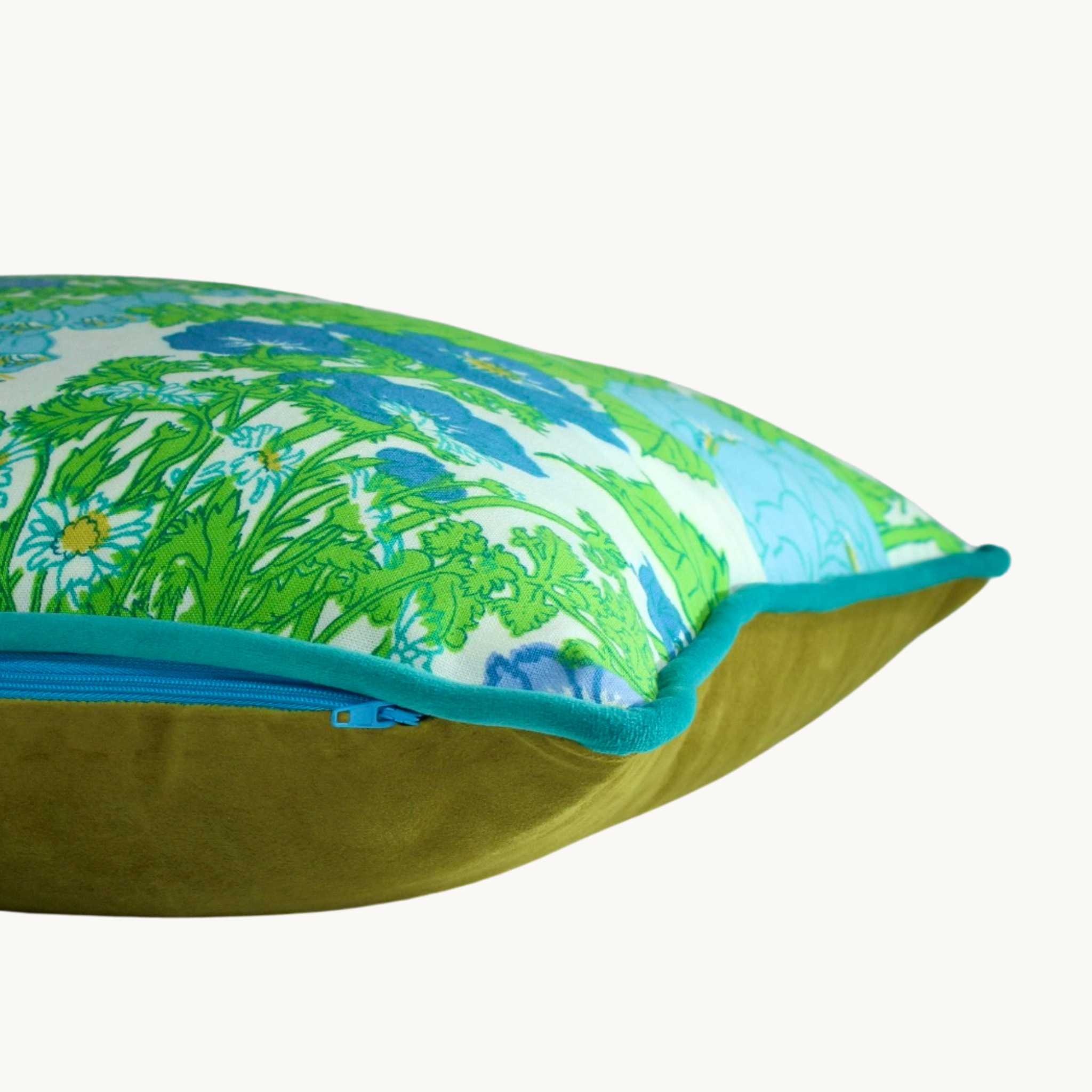 Side shot of a very bright floral cushion in lime green with periwinkle blue and violet flowers