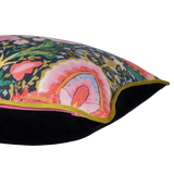 Side shot of a brightly coloured cushion with flowers and peace signs