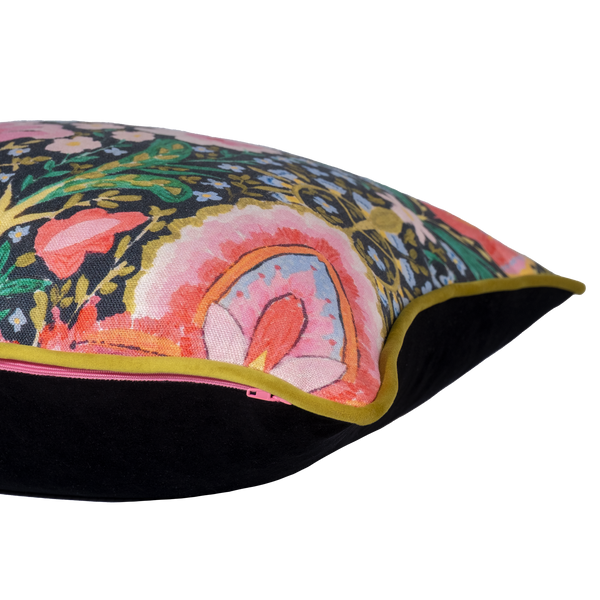 Side shot of a brightly coloured cushion with flowers and peace signs