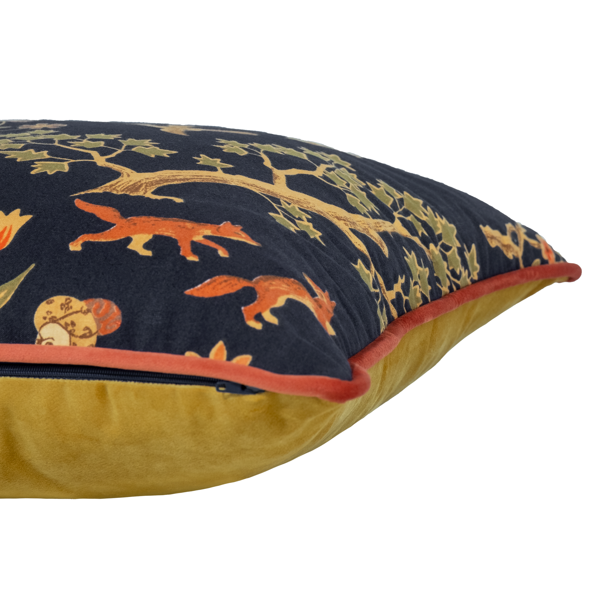 Decorative cushion with intricate patterns of animals and a person on a horse against a dark background.