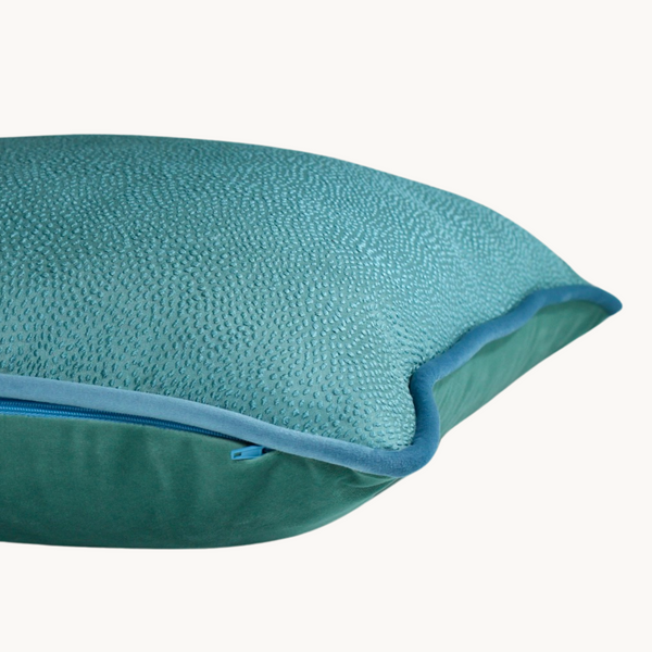Side shot of a topaz blue cushion with a subtle textured spot