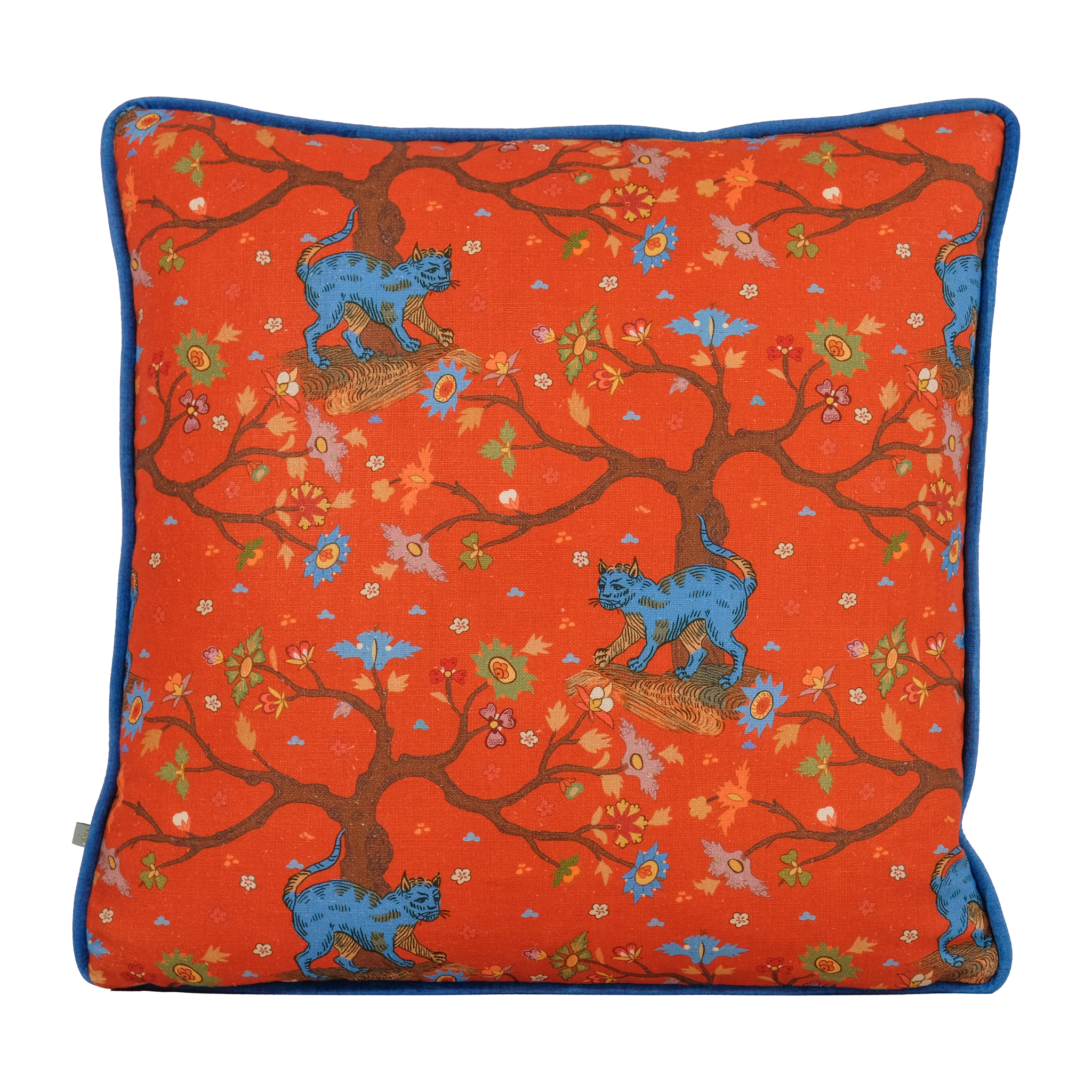 A square decorative throw pillow featuring a vibrant orange-red background printed with brown tree branches, blue lions, and small floral motifs, finished with a contrasting blue piping border.