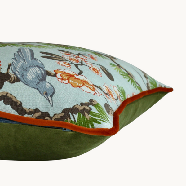 Sides shot of a cushion with birds and oriental inspired flora