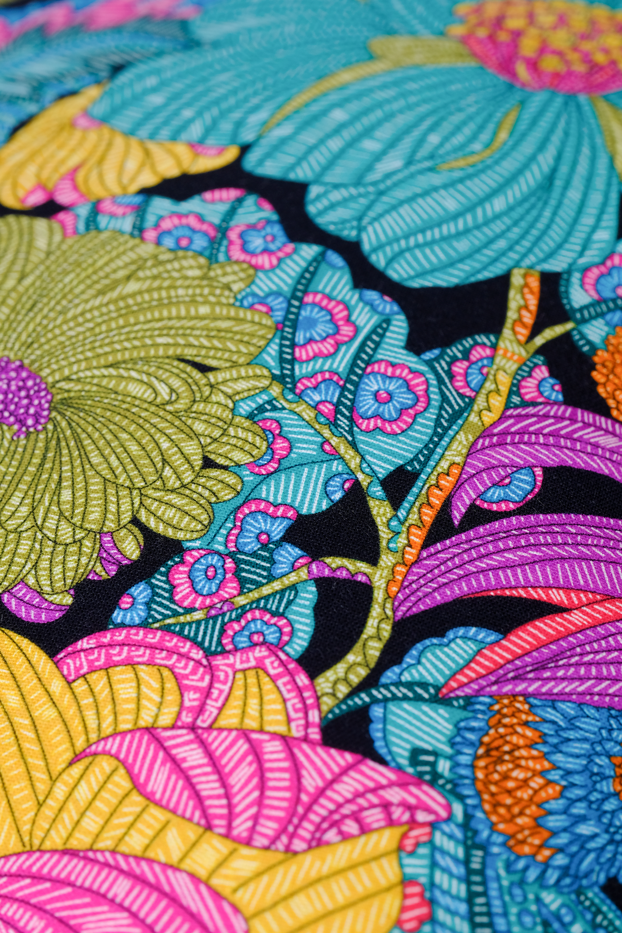 Close-up of a vibrant floral pattern with colorful flowers on a black background