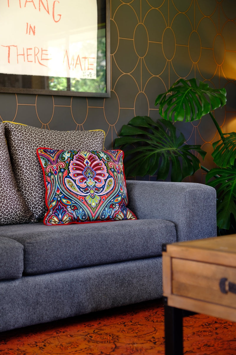Lounge setting with a brightly coloured cushion on a sofa