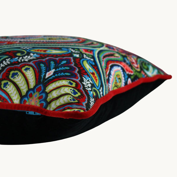 Side photo of a brightly coloured velvet cushion with a design inspired by motifs from the Ottoman Empire.