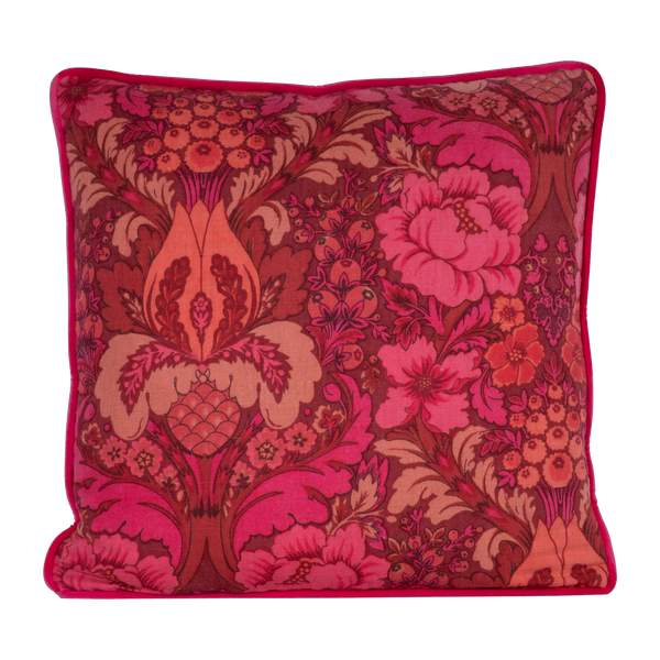 Photo of a cushion made from a punchy vintage damask in hot pink, coral and red
