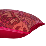 Side shot of a cushion made from a punchy vintage damask in hot pink, coral and red