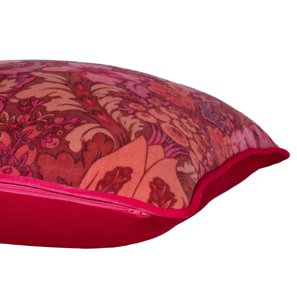 Side shot of a cushion made from a punchy vintage damask in hot pink, coral and red