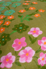 Floral pattern with pink, green, and orange flowers on a green background