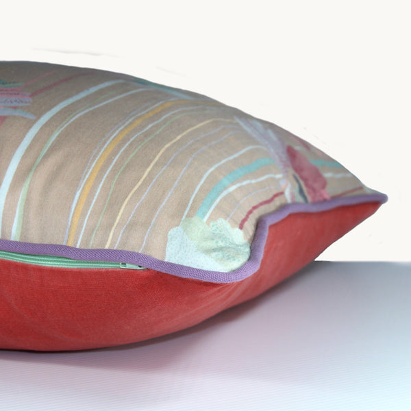 Sideshot of a square cushion with a biscuit coloured base and large painterly pastel flowers with lines in the same colours through the background