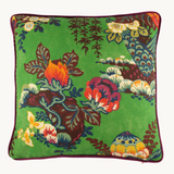 Photo of a square linen cushion with a bright emerald background and large scale bunch of interesting flowers and branches in yellow, red, navy and chocolate.